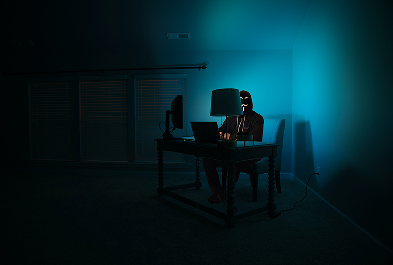 Hacker sitting in front of a computer